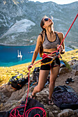 Woman belaying during rock climbing, Kalymnos, Greece