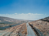 Aerial view of two cyclists pedaling on road, Lanzarote, Canary Islands, Spain