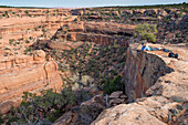 Woman looking into canyon below Moon House ruins, Cedar Mesa, Bears Ears National Monument, Utah, USA