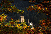 Autumn frame Nossa Donna church and Tower of Castelmur, Bondo, Maloja region, Canton of Graubunden, Bregaglia valley, Switzerland, Europe