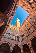 Siena, Tuscany, Italy, Europe. Classic bottom view of Palazzo Pubblico with Del Mangia's Tower at dawn.
