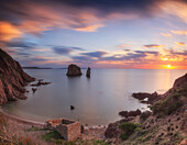Portu Banda beach at sunset, Nebida, Iglesias, Sardinia, Italy. There are two large faraglioni (Aragustieri)