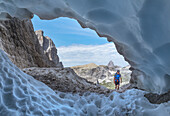 Italy, South Tyrol, Hocpustertal, Sexten. Snow cave in the summer season along the Alpinisteig / Strada degli alpini via ferrata, Sexten Dolomites