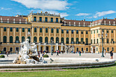 Vienna, Austria, Europe. The Schönbrunn Palace at sunrise. A fountain in the forecourt with the sculptures Galicia, Volhynia, and Transylvania