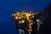 Como lake, provence of Lecco, the lights of Varenna village by night. Lombardy, Italy