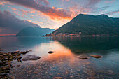 The lake shore and Peschiera Maraglio at sunset, Montisola, Iseo lake, Brescia province, Lombardy district, Italy