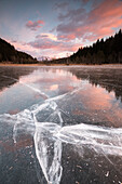 Sunset on ice of lake in Pian Gembro, Aprica, Province of Sondrio, Valtellina, Lombardy, Italy, Europe