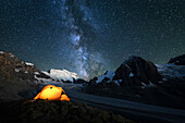 Illuminated tent by nigh with milky way, camping close to the Grand Combin glacier, Grand Combin on background,Switzerland,Swiss