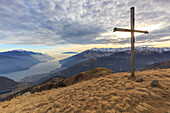 The Bodone cross at sunset, in the background Como lake, Lombardy, Italy, provence of Como