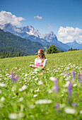 A girl in typical dress into the alpine landscape of GErold, Garmisch Partenkirchen Land, Bayern, Germany