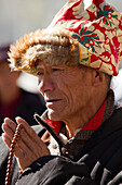 Man praying at the Jokhang Temple of Barkhor Square, Lhasa, Tibet, China, Asia