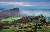 Morning mist and fog clear the landscape to reveal Hen Cloud and the gritstone rocks of the Roaches, Peak District, Derbyshire, England, United Kingdom, Europe