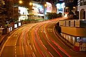 Car light trails on a busy road in Central, Hong Kong Island by night, Hong Kong, China, Asia