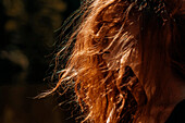 Wind blowing red hair of Caucasian woman