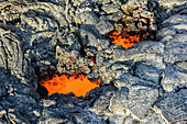 Molten lava glowing near dried lava