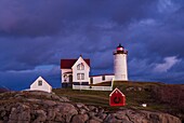 USA, Maine, York Beach, Nubble Light Lighthouse with Christmas decorations, dusk.