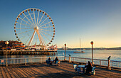 People enjoying the view of Seattle Great Wheel from Waterfront Park in Seattle, Washington State, United States of America, North America