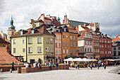 Tourists walk across Castle Square Plac Zamkowy, site of Sigismund's Column and Royal Castle, Old Town rebuilt after World War II, UNESCO World Heritage Site, Warsaw, Poland, Europe