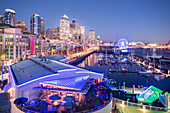 Elevated view of Seattle skyline and restaurants in Bell Harbour Marina at dusk, Belltown District, Seattle, Washington State, United States of America, North America