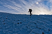 Hiker at sunrise in winter, Monte Cucco Park, Apennines, Umbria, Italy, Europe