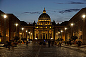 St. Peter's Cathedral night view with passing crowd, from Via della Conciliazione, Rome, Lazio, Italy, Europe