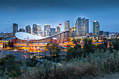 View of the Saddledome and Downtown skyline from Scottsman Hill at dusk, Calgary, Alberta, Canada, North America