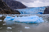 Ice pack and blue ice face of South Sawyer Glacier, mountain backdrop, Stikine Icefield, Tracy Arm Fjord, Alaska, United States of America, North America