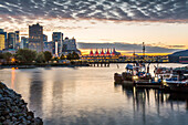View of Canada Place and urban office buildings at sunset from CRAB Park, Vancouver, British Columbia, Canada, North America