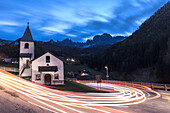 Lights of car trails around the Church of San Cipriano, Tires Valley, Dolomites, South Tyrol, Bolzano province, Italy, Europe