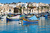 Traditional brightly painted fishing boats in the harbour at Marsaxlokk, Malta, Mediterranean, Europe