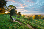 Cotswold Way path and bench with views to the Malvern Hills at sunset, Ford, Cotswolds, Gloucestershire, England, United Kingdom, Europe