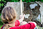 Archery tourist in the Stone Age village Kussow, Baltic Sea Coast, Mecklenburg-Vorpommern, Germany