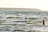 Bathers in the waves on the beach, Warnemünde, Rostock, Ostseeküste, Mecklenburg-Vorpommern, Germany