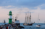 Sailboats in Warnemünde with onlookers and lighthouse to the Hanse Sail, Warnemünde, Rostock, Baltic Sea coast, Mecklenburg-Vorpommern, Germany