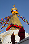 Tibetan Buddhist monks and Boudhanath Stupa, UNESCO World Heritage Site, Kathmandu, Nepal, Asia