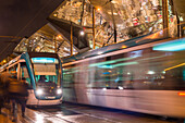 Night view of two trams at Glories station with the dazzling, reflective canopy to the rear, Barcelona, Catalonia, Spain, Europe