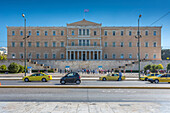 Parliament building and yellow cabs in Syntagma Square, Athens, Greece, Europe
