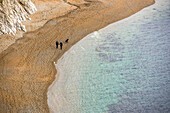Couple and dog walking along the beach, Jurassic Coast, UNESCO World Heritage Site, Dorset, England, United Kingdom, Europe