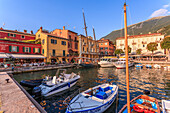 View of boats in Malcesine Harbour by the Lake, Malcesine, Lake Garda, Veneto, Italian Lakes, Italy, Europe