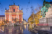 Ornate facade of Franciscan Church of the Annunciation and Preseren Monument in Plaza Presernov at dusk, Ljubljana, Slovenia, Europe