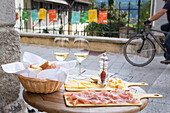 Table with local wine and delicatessen like cheese and cured ham on terrace in Radovljica, Triglav, Slovenia