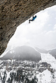 Man rock climbing overhanging cave route called Pull the Trigger Tigga at Hall of Justice, Camp Bird Road, Uncompahgre National Forest, Ouray, Colorado, USA