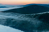 Fog in forest rising from Echo Lake at dawn in Acadia National Park, Maine, USA