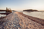 The sun sets over a natural sea wall along the Schoodic Peninsula in Maine's Acadia National Park.