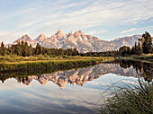 The Tetons are reflected in the Snake River near Jackson Hole, Wyoming.