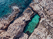 Aerial view of swimming pool on rocky seashore, Es Cau, Costa Brava, Catalonia, Spain