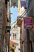 Narrow street in the old town of Korcula Town with view to the Saint Mark's cathedral, Korcula, Croatia, Europe