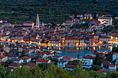 View from the lookout atop Glavica Hill over Stari Grad on Hvar Island at dusk, Hvar, Croatia, Europe