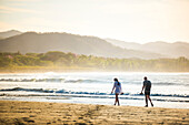 Couple on Playa Buena Vista Beach at sunrise, Guanacaste Province, Costa Rica, Central America