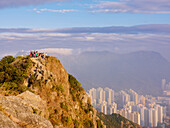 Hikers at the Lion Rock mountain peak, viewing the city of Hong Kong from a high point, Hong Kong, China, Asia